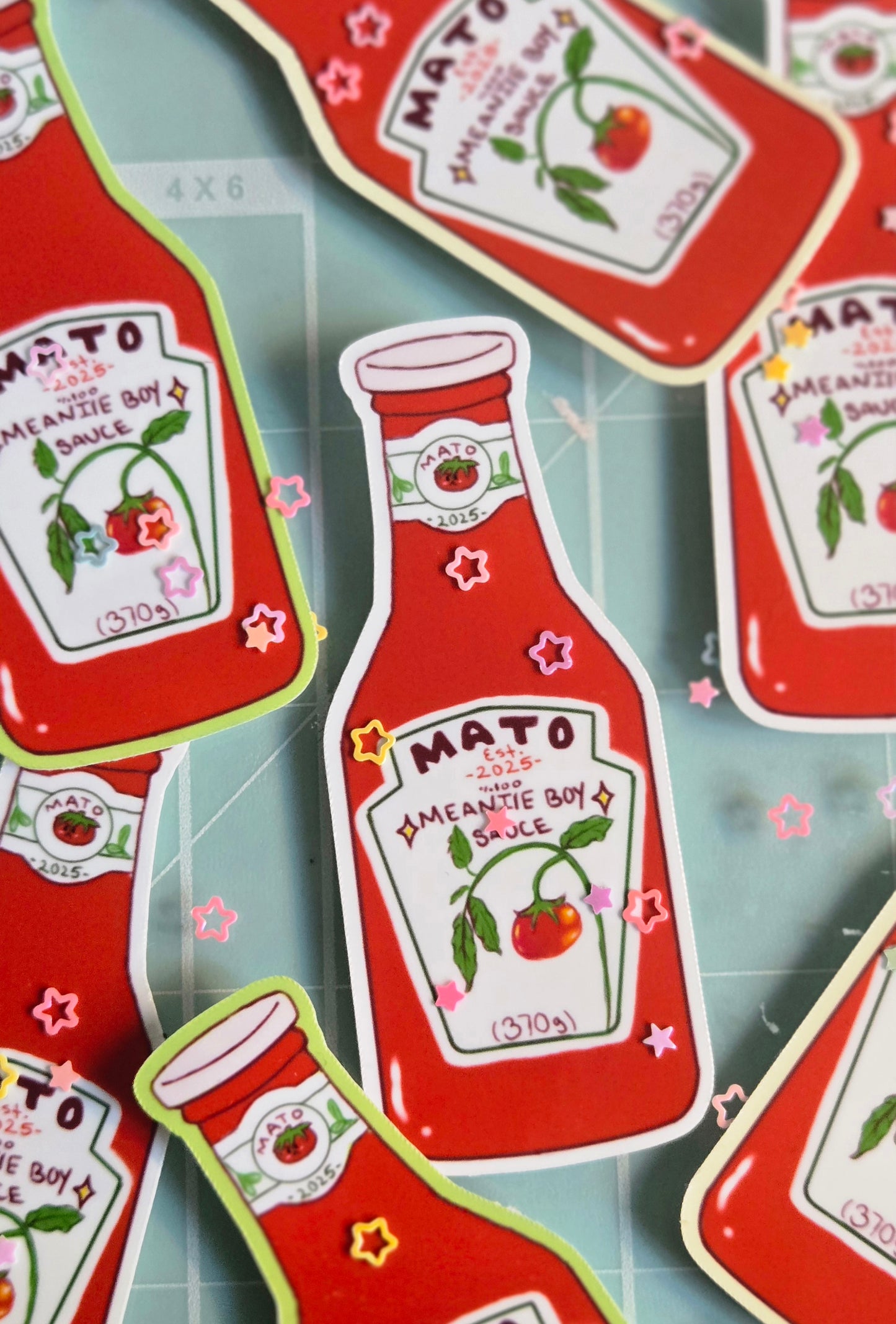Red ketchup bottle-shaped stickers with 'Mato' branding on a gray background.